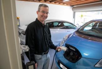 A man charging his ev nissan leaf